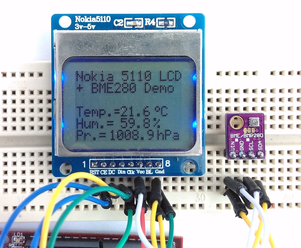 Weather station displaying temperature, humidity, and pressure shown in hPa unit.