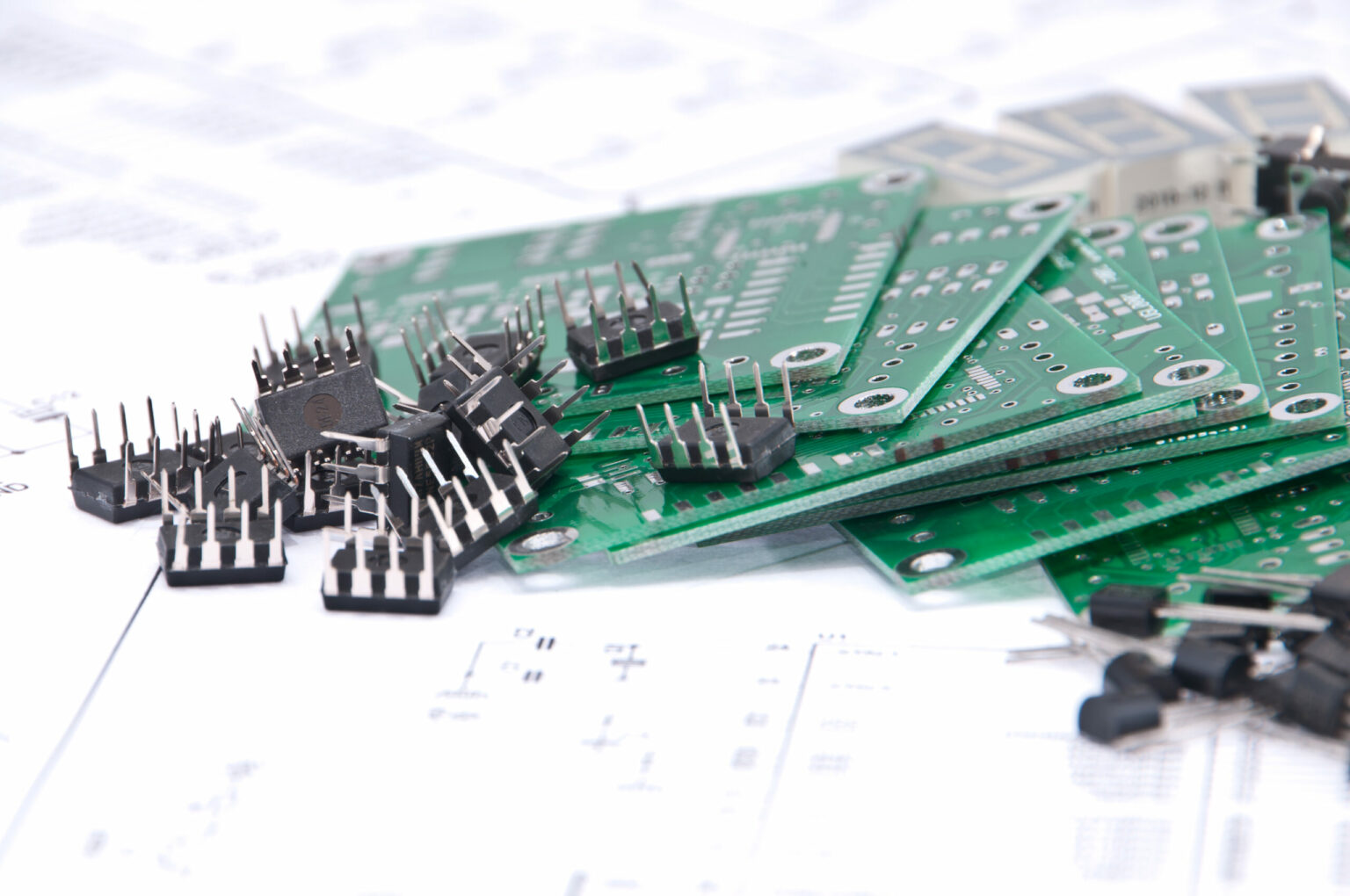Circuit boards and components with schematics in background